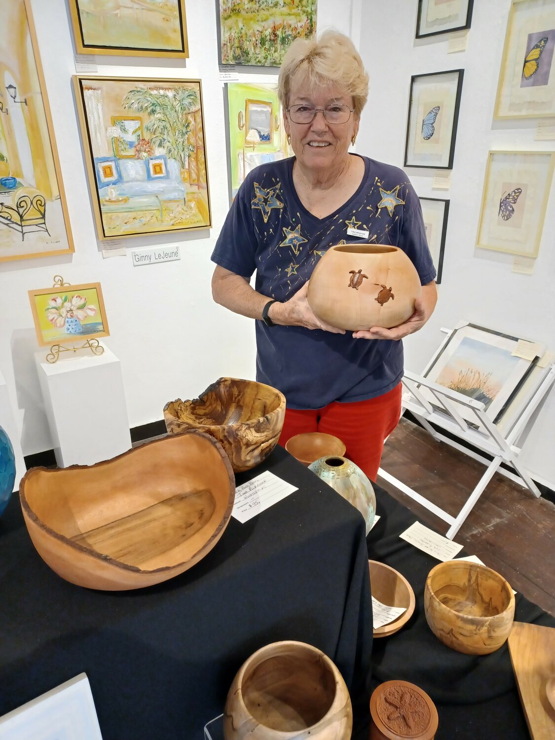 Tina Minahan is seen with some of her creations inside the PAStA Fine Arts Gallery in St. Augustine.